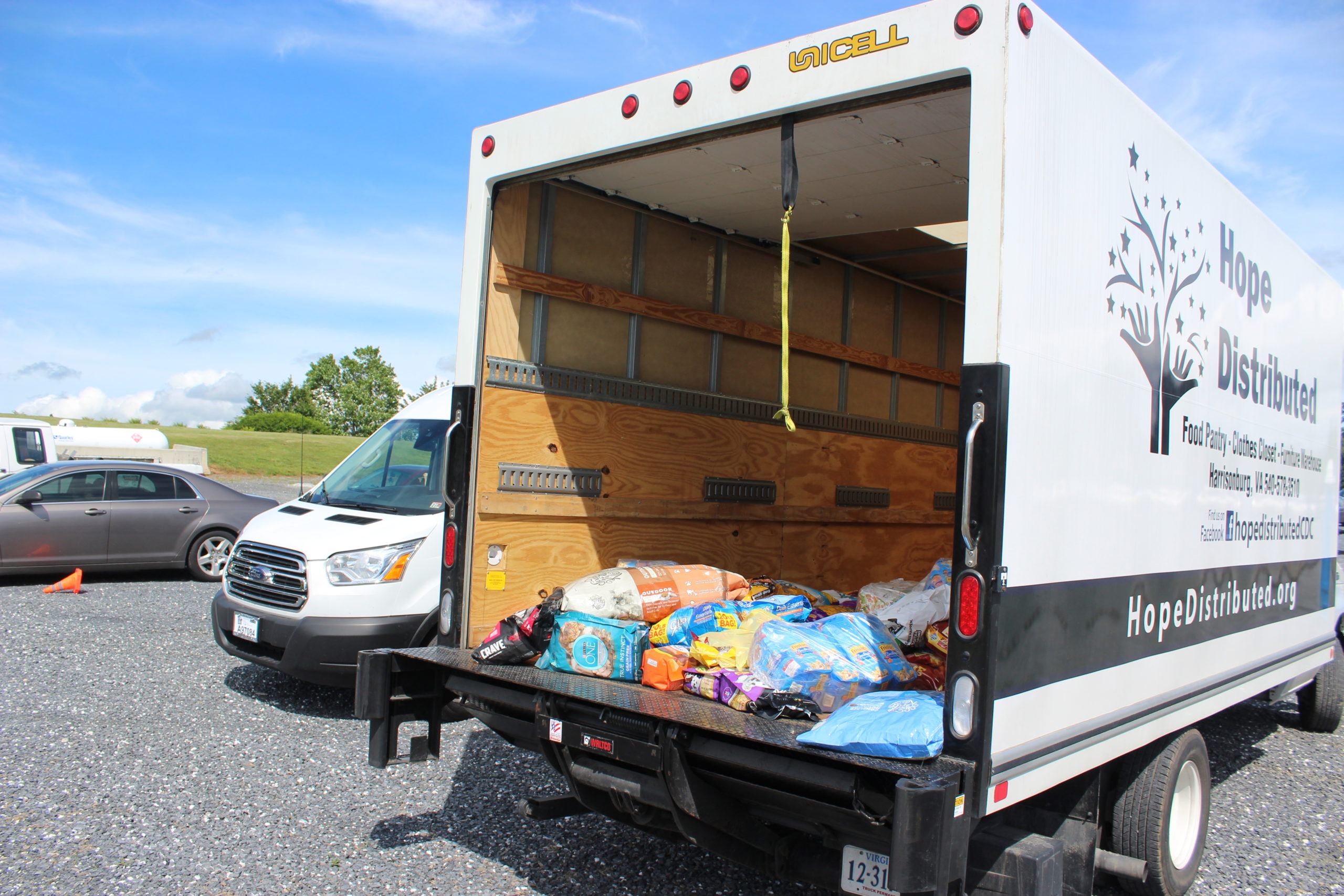 Pet food sitting in the back of a large truck