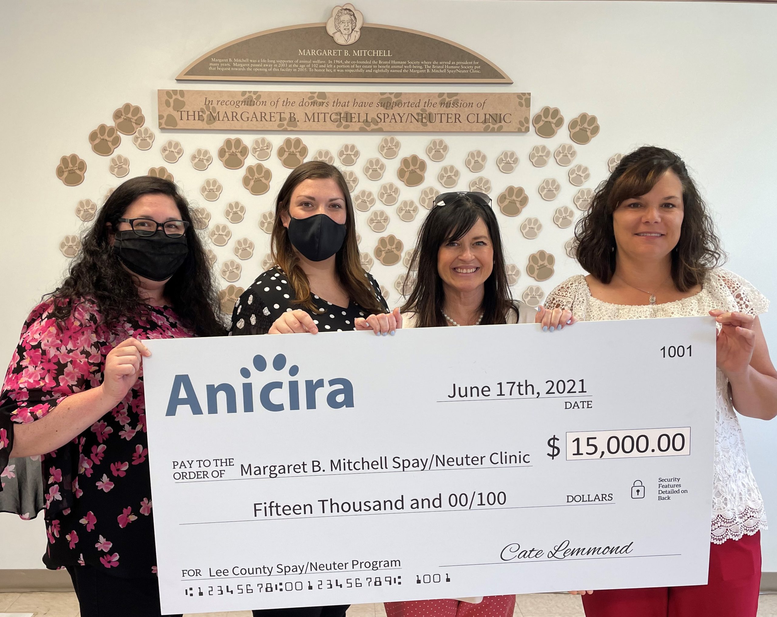 Anicira's SEO and Practice Manager present a check for $15000 to MBM Spay/Neuter Clinic