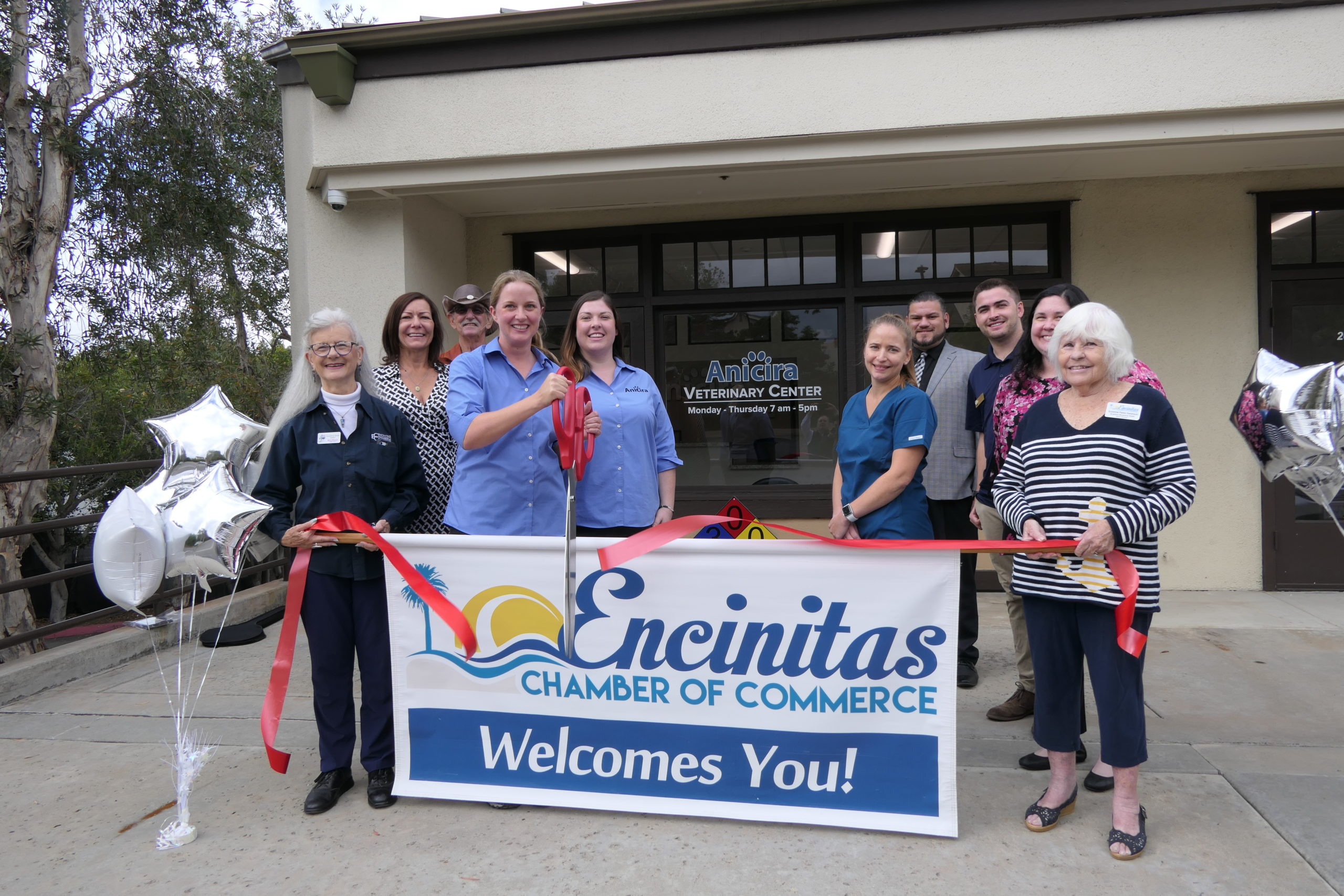 Ribbon cutting of new Anicira clinic in San Diego. The sign in the image reads: Encinitas chamber of commerce welcomes you!